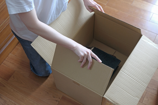 段ボールに荷物を箱詰めする様子